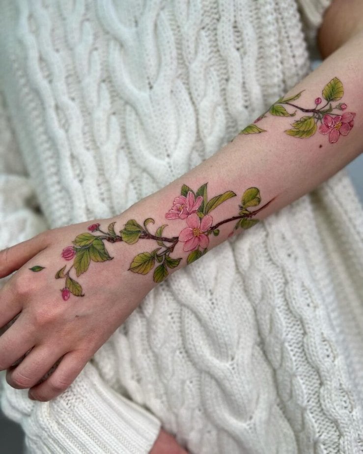 18. A beautiful apple branch tattoo across the arm