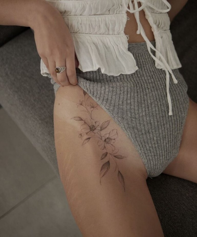 5. An apple tree branch tattoo on the upper thigh