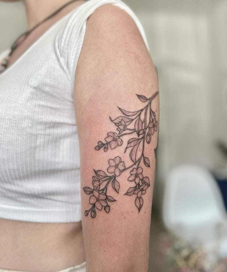 7. An apple tree branch tattoo on the upper arm