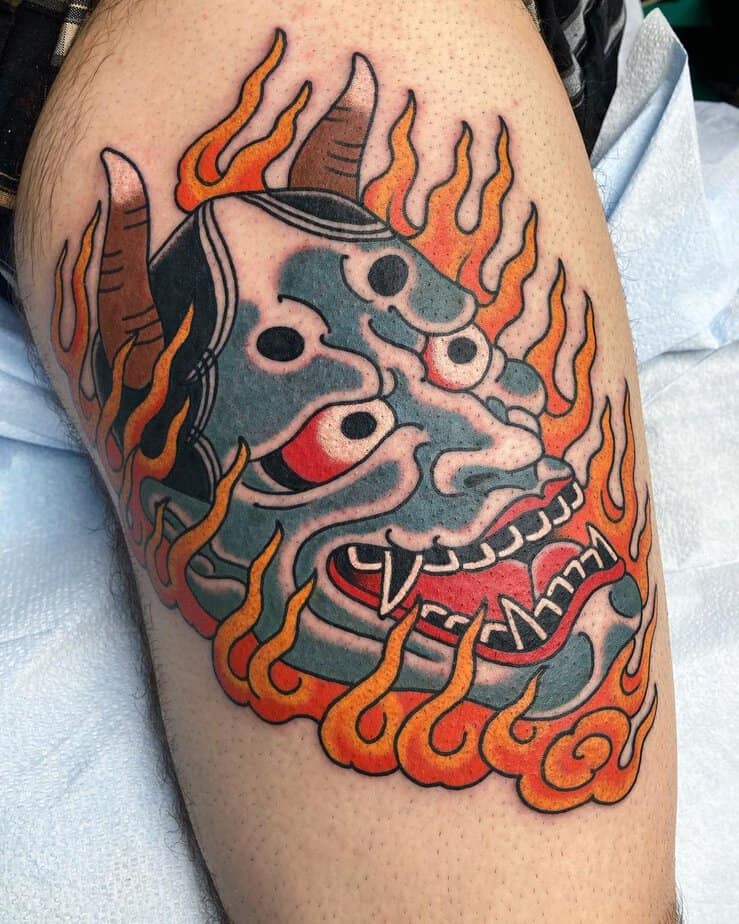 Hannya mask surrounded by bright orange flames