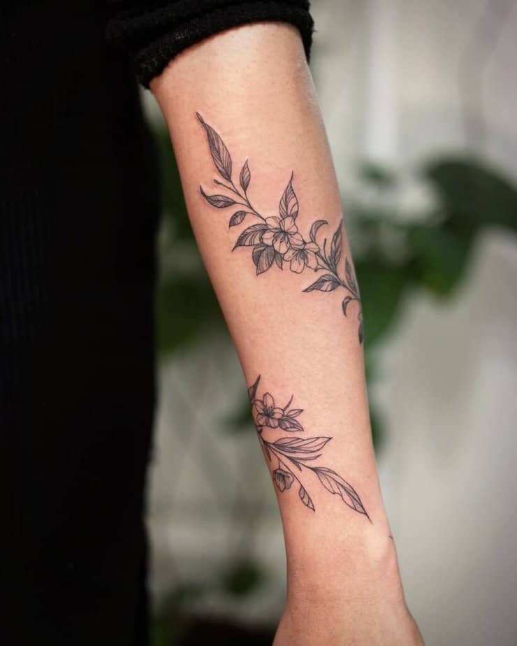 Vine with flowers forearm tattoo