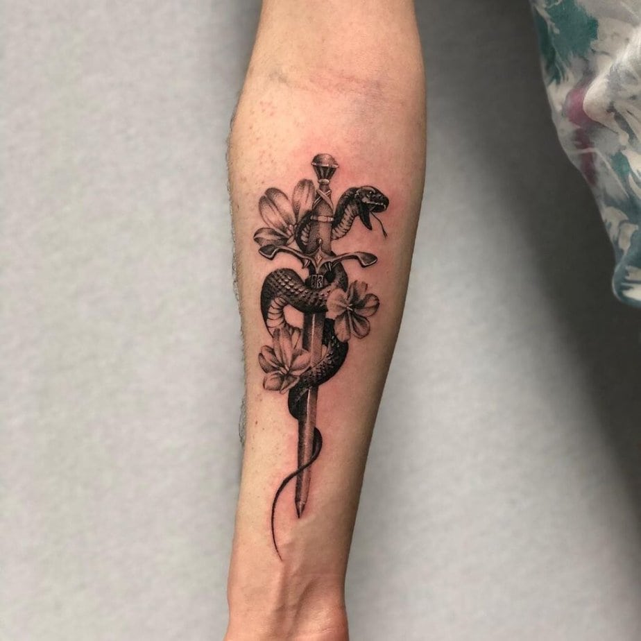Snake and dagger forearm tattoo