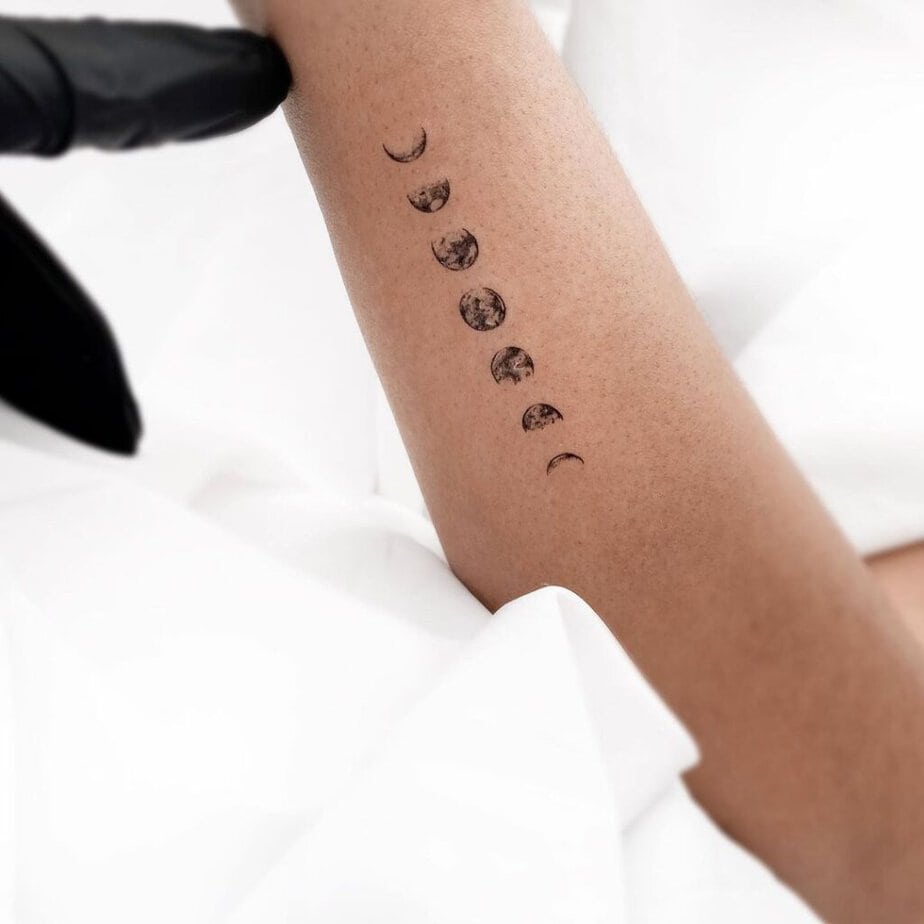 Moon phase forearm tattoo