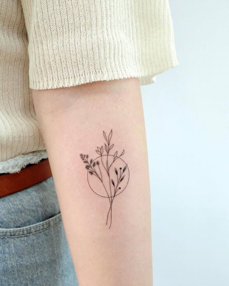 Fine-line flower forearm tattoo