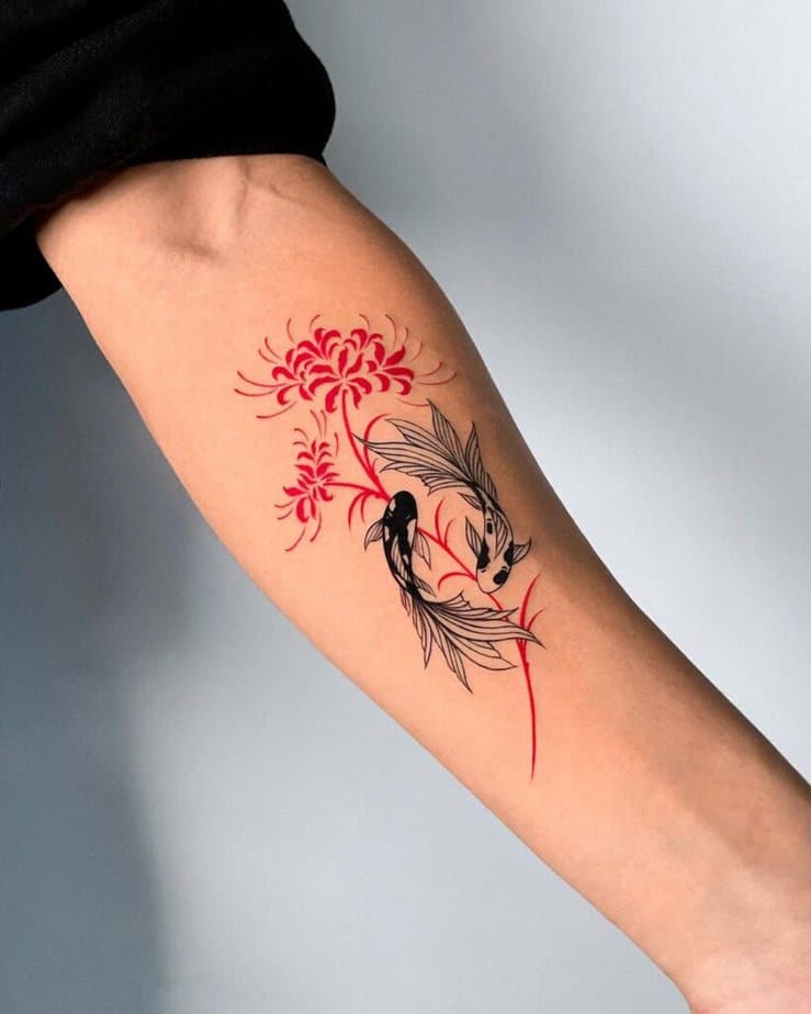 Black and red koi fish forearm tattoo