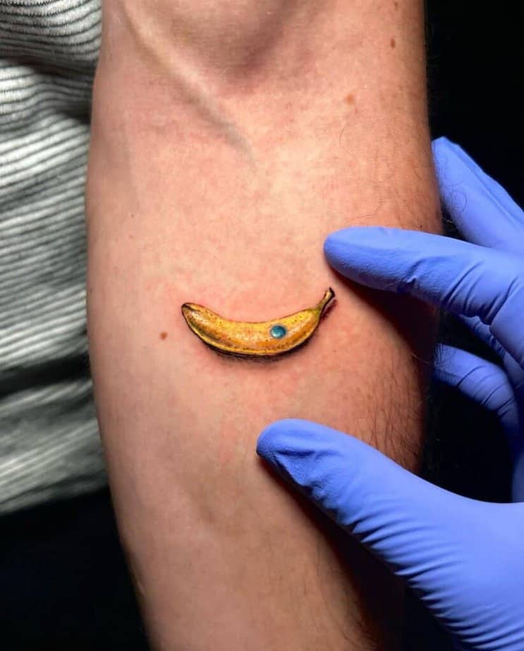 17. A micro realism banana tattoo