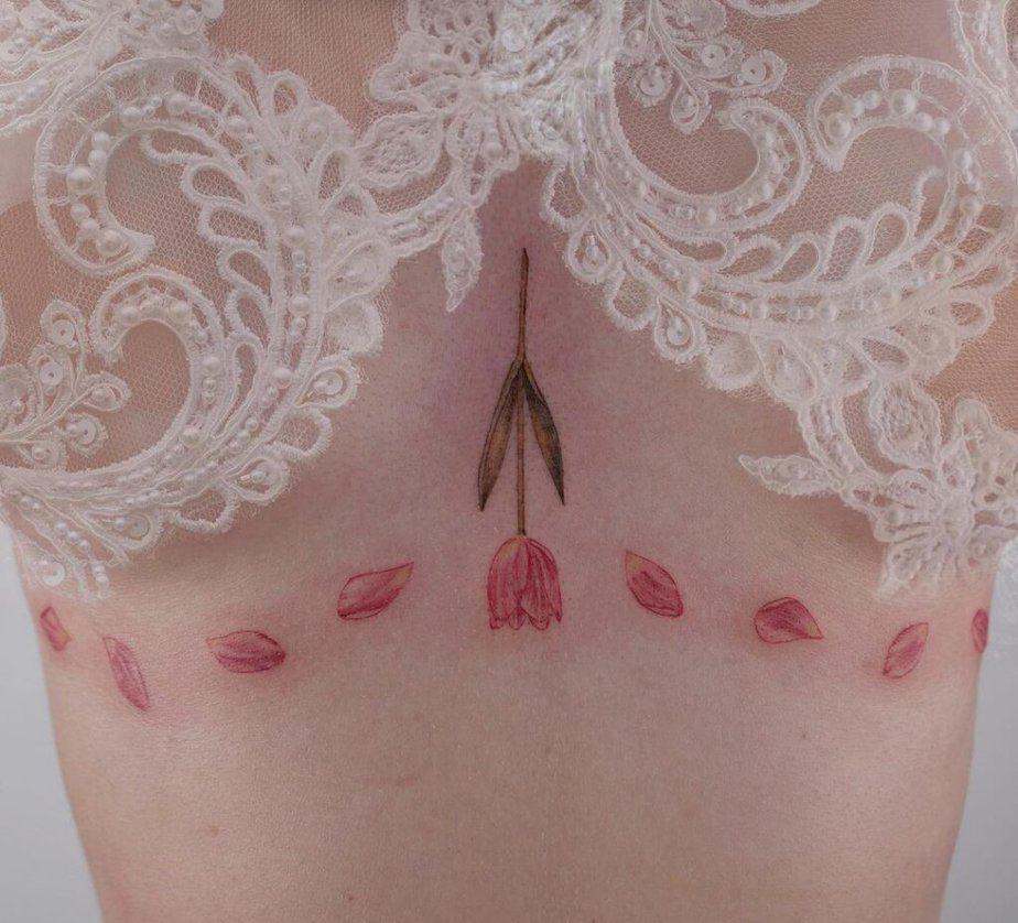 Colored under-breast tattoos