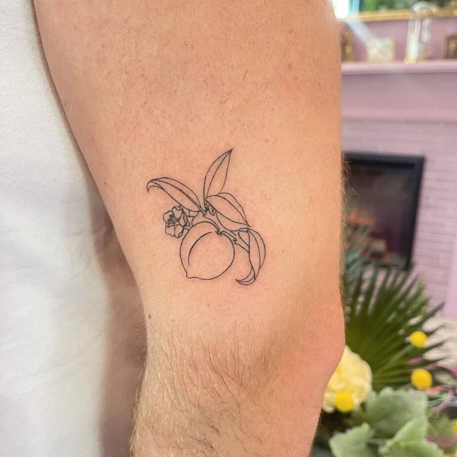 23. A line-art peach tattoo 