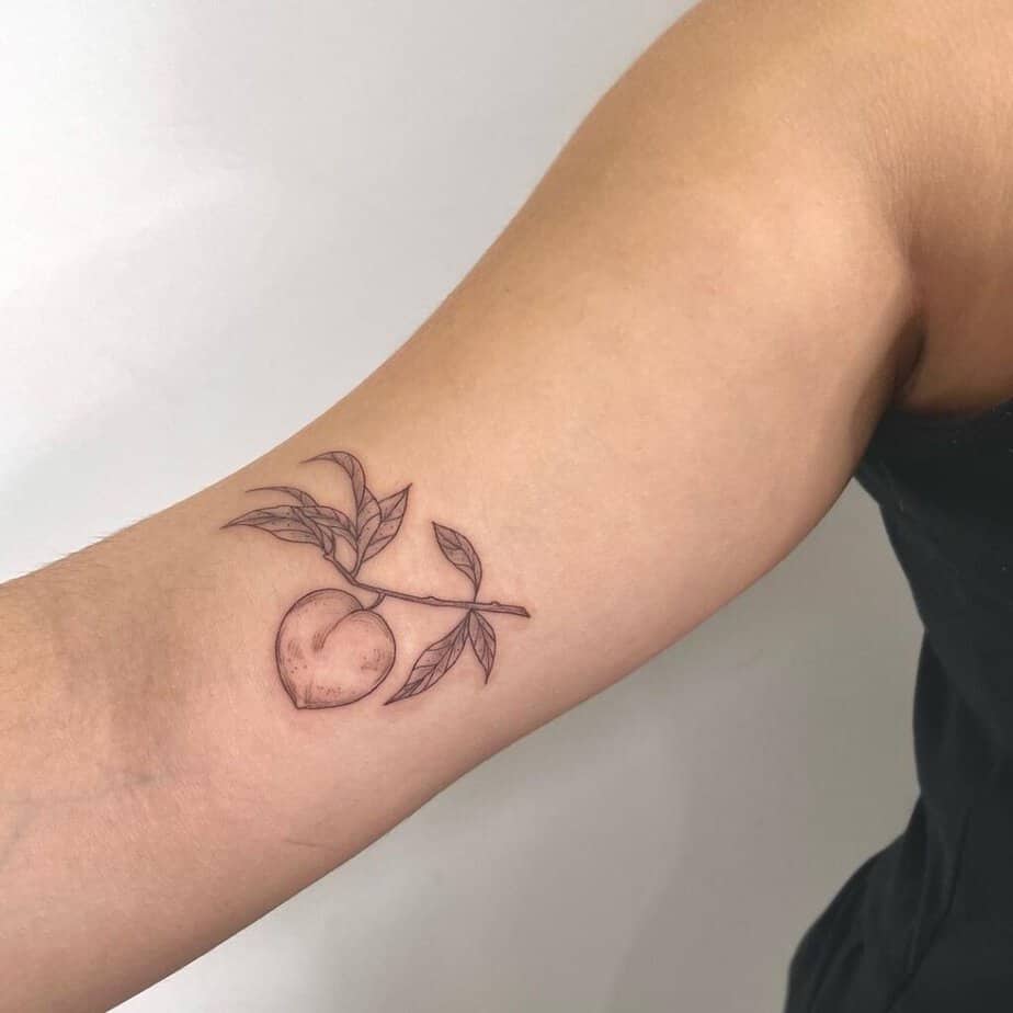 3. A fine-line peach tattoo 