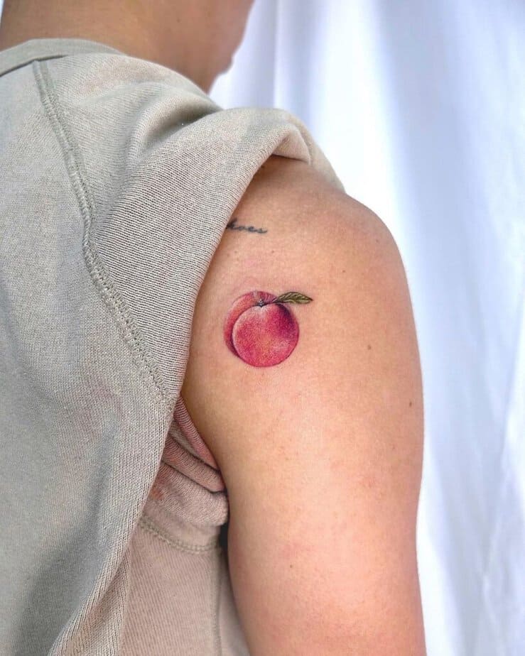 6. A tattoo of a peach on the shoulder 
