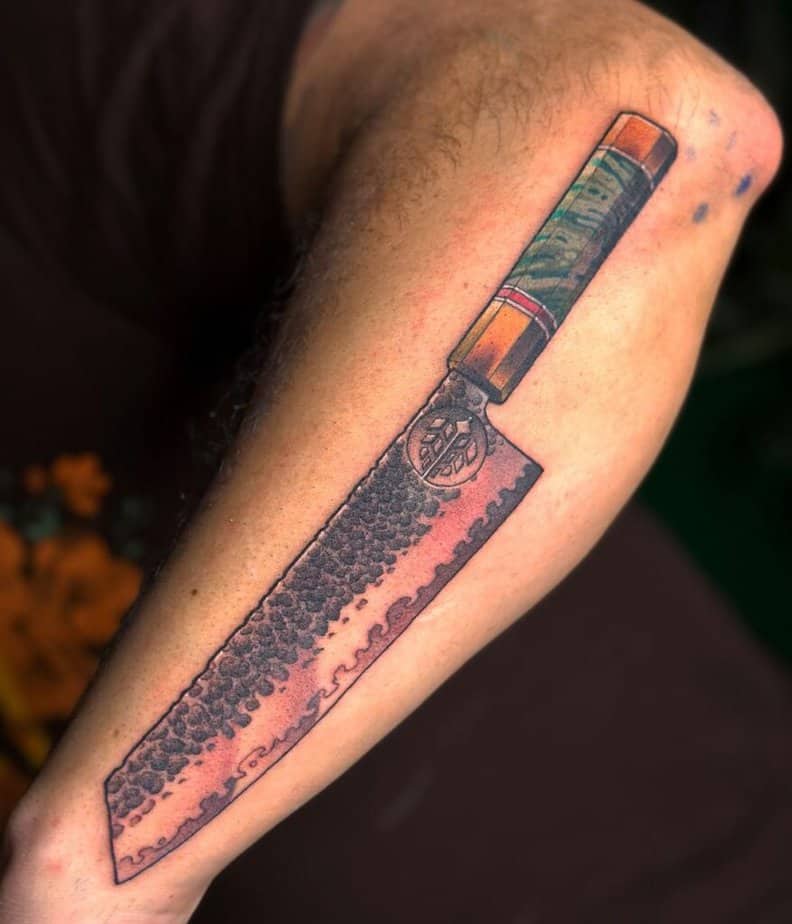22. A tattoo of a Kiritsuke knife on the forearm