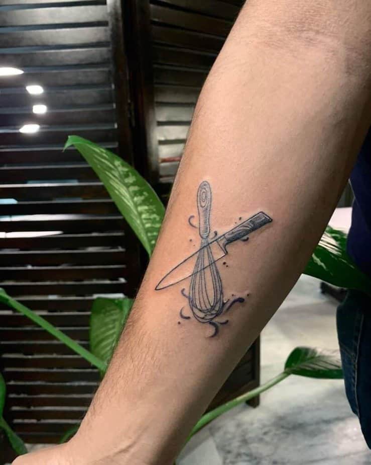4. A tattoo of a knife and whisk on the inside of the arm