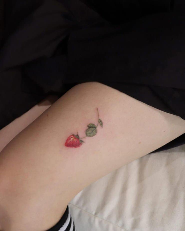 16. A strawberry tattoo on the leg