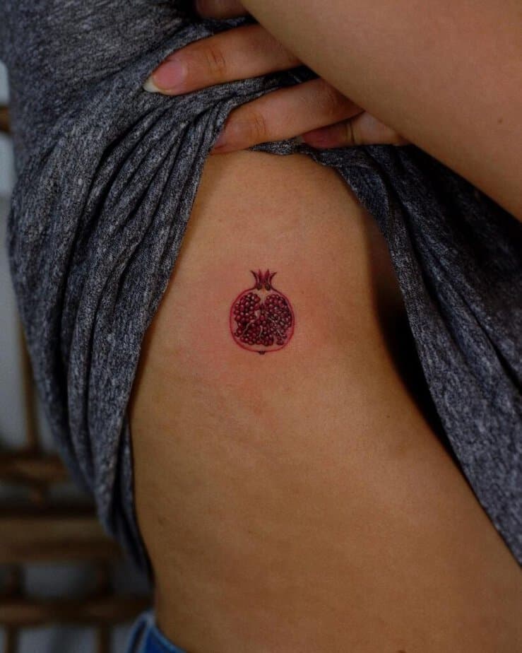 20. A pomegranate tattoo on the rib