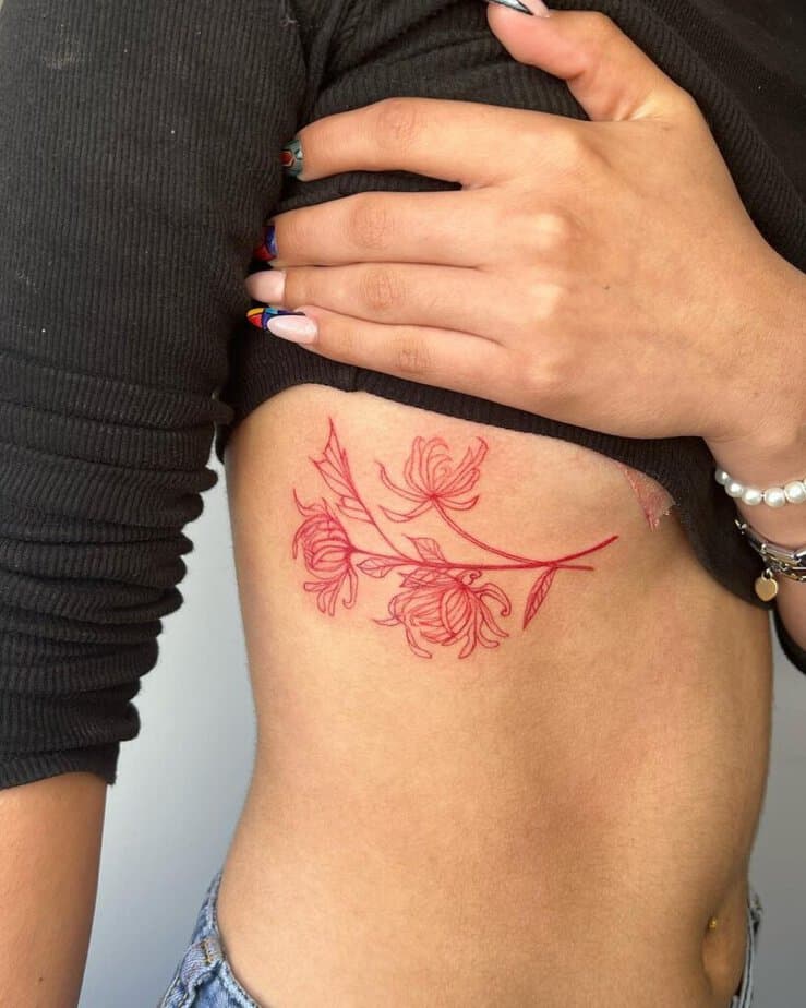 Red ink rib tattoo