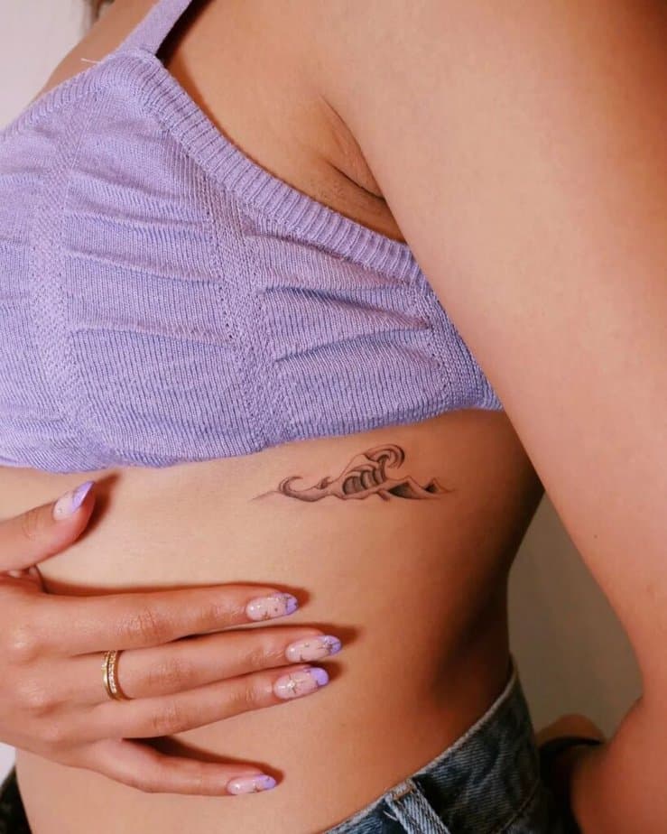 Wave tattoo on the rib