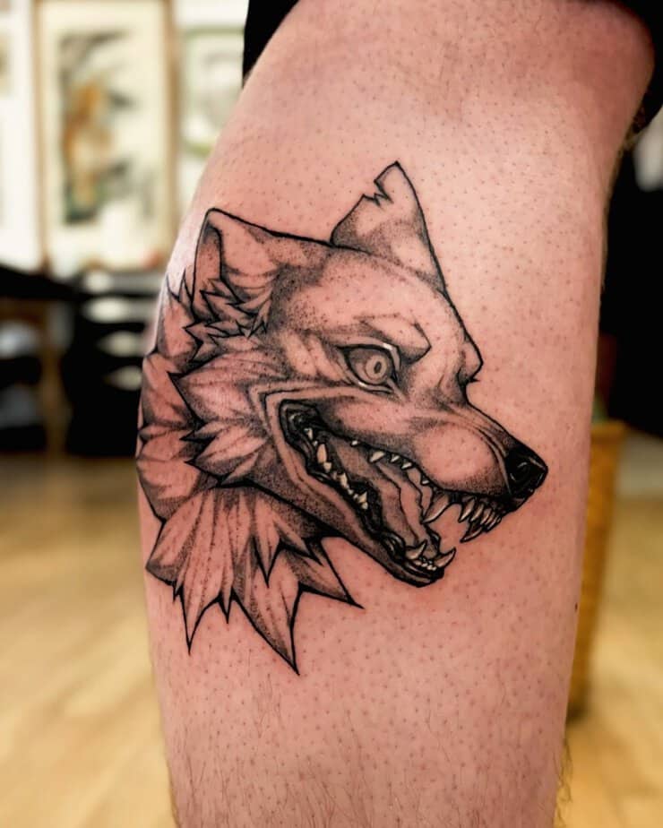 Ferocious wolf with sharp teeth tattoo