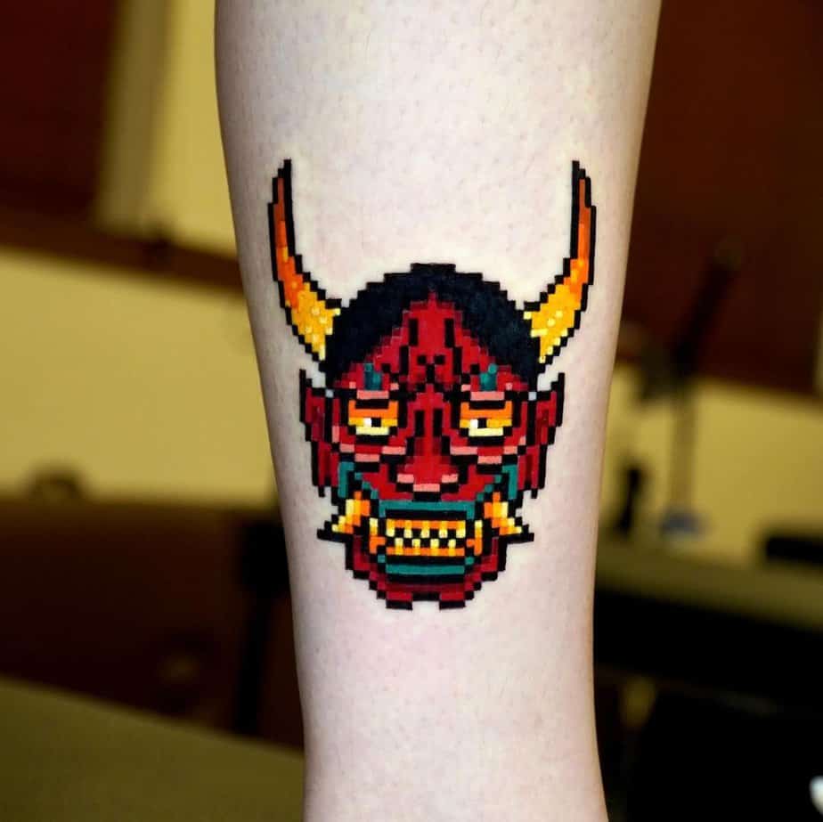 Pixelated 8-bit Hannya tattoo