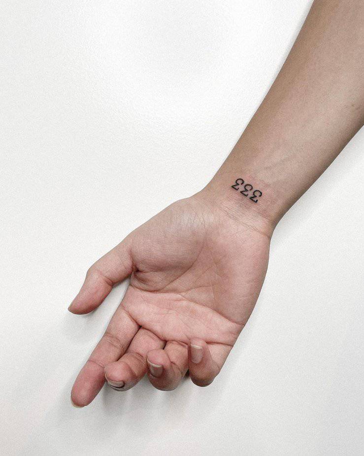 A small wrist 333 tattoo