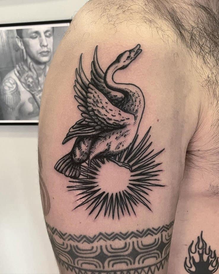 Swan standing on top of the sun tattoo