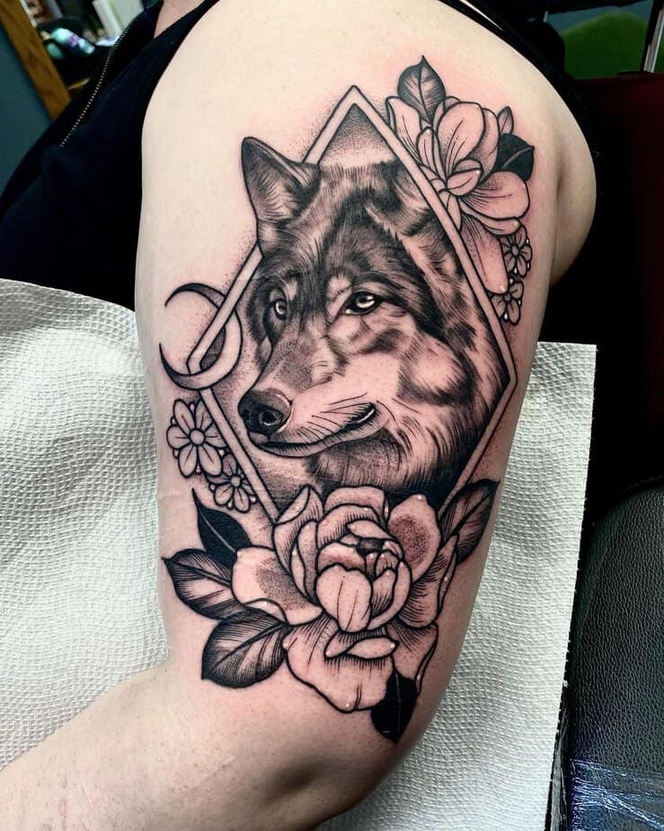 Wolf framed by flowers tattoo