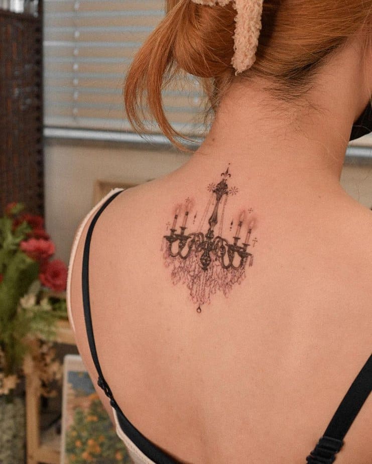 Vintage chandelier tattoo on upper back