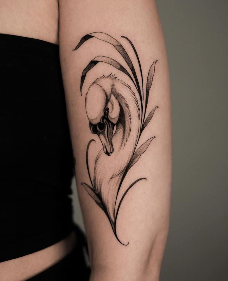 Elegant swan tattoo among foliage