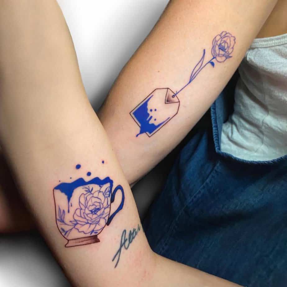 Matching blue-and-white teacup tattoos with roses