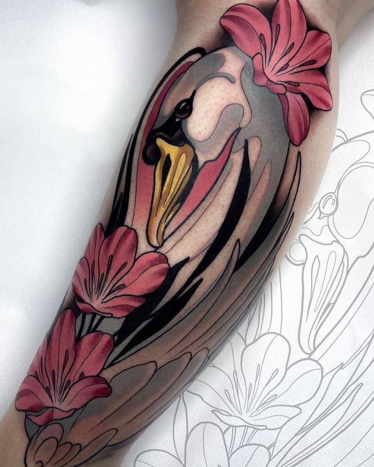 A swan among colorful flowers tattoo