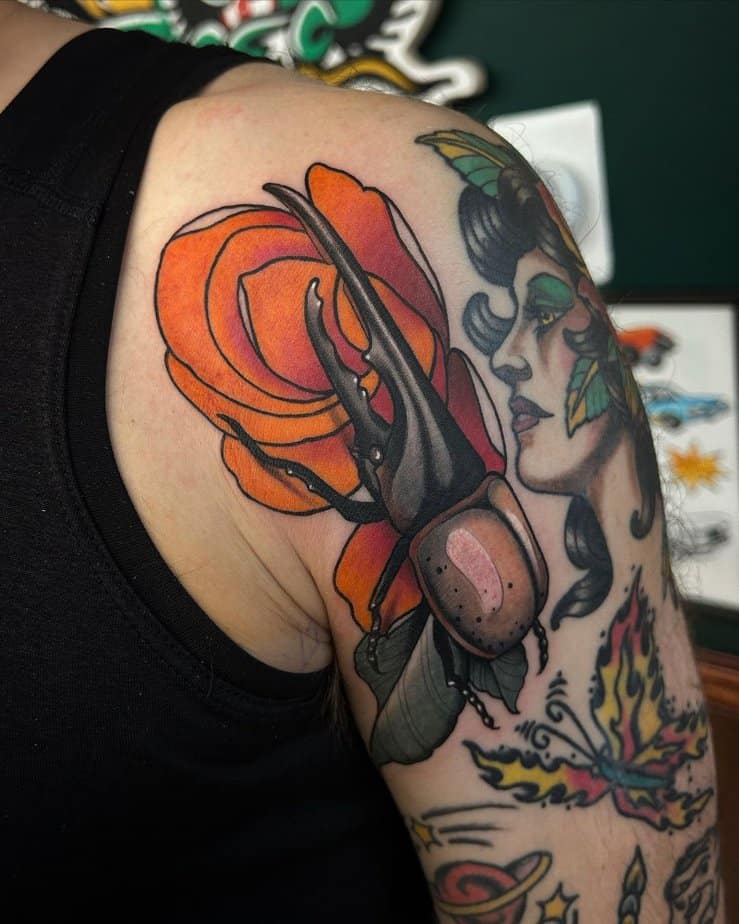 Beetle beside a vibrant red rose