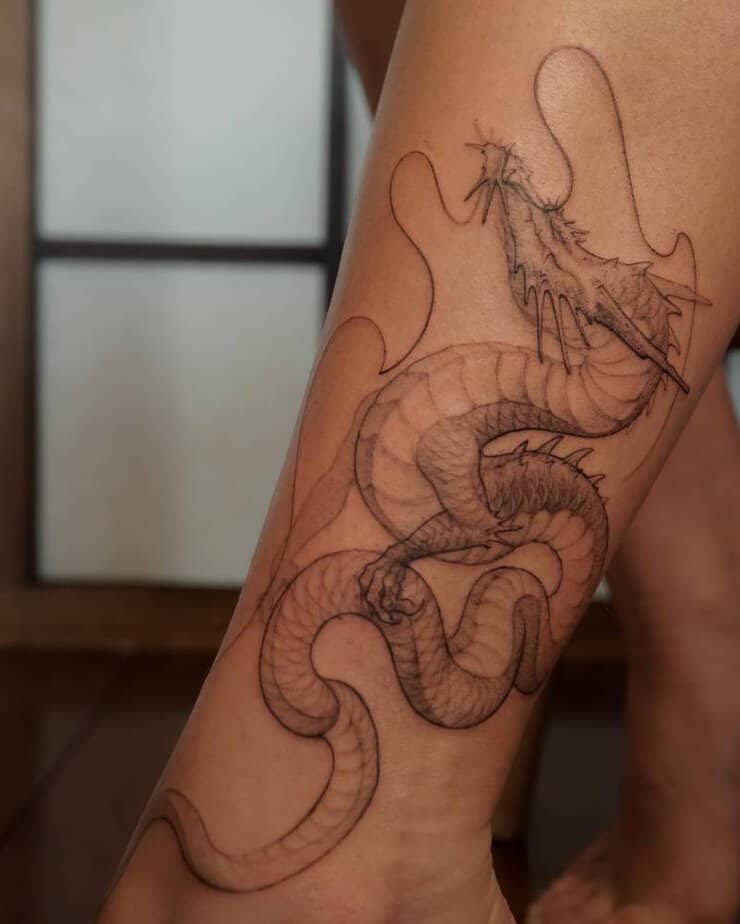 Dragon tattoo winding up the leg