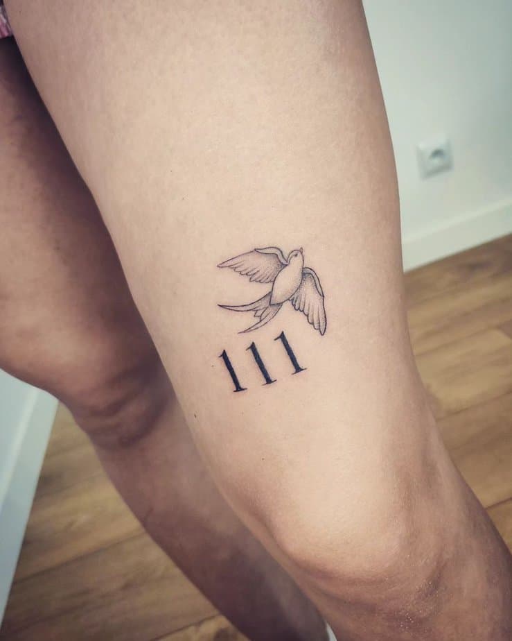 Soaring bird and 111 tattoo