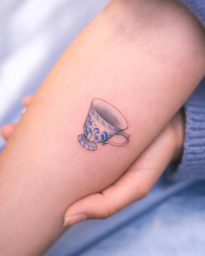 Delicate tiny teacup with antique blue pattern