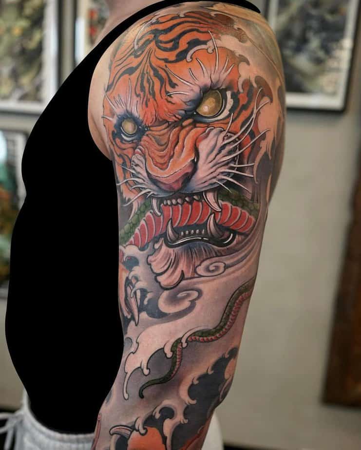 Arm tattoo combining a tiger with a Hannya mask