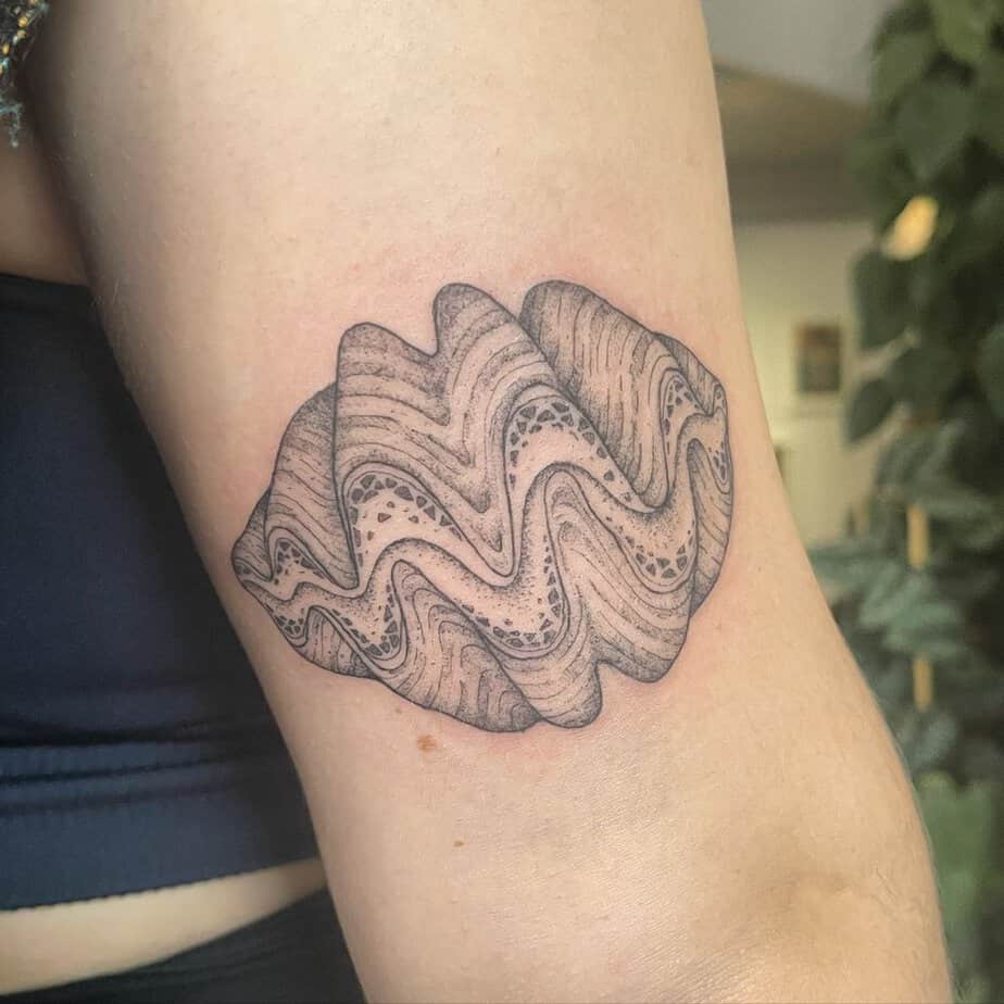 20. A clam tattoo on the arm