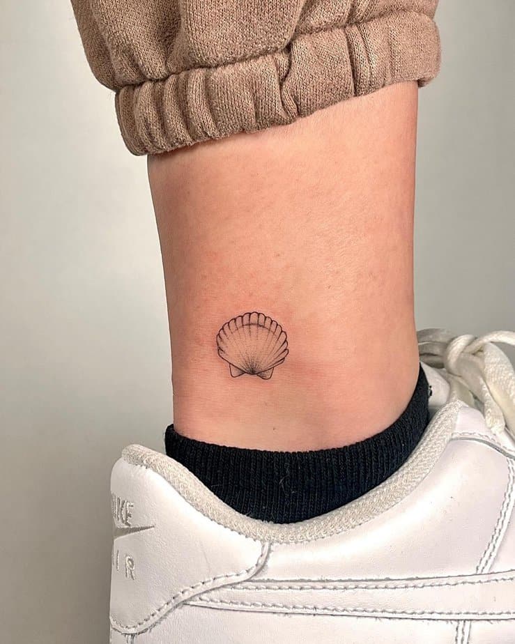 9. A cockle shell tattoo on the ankle