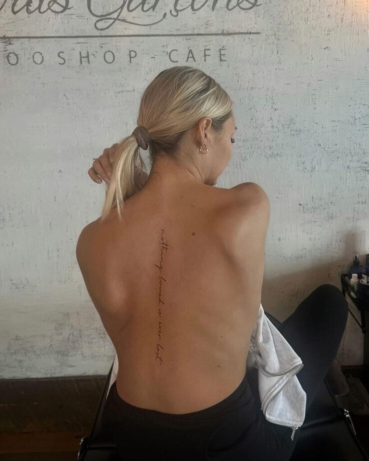 A cute spine tattoo featuring an empowering quote