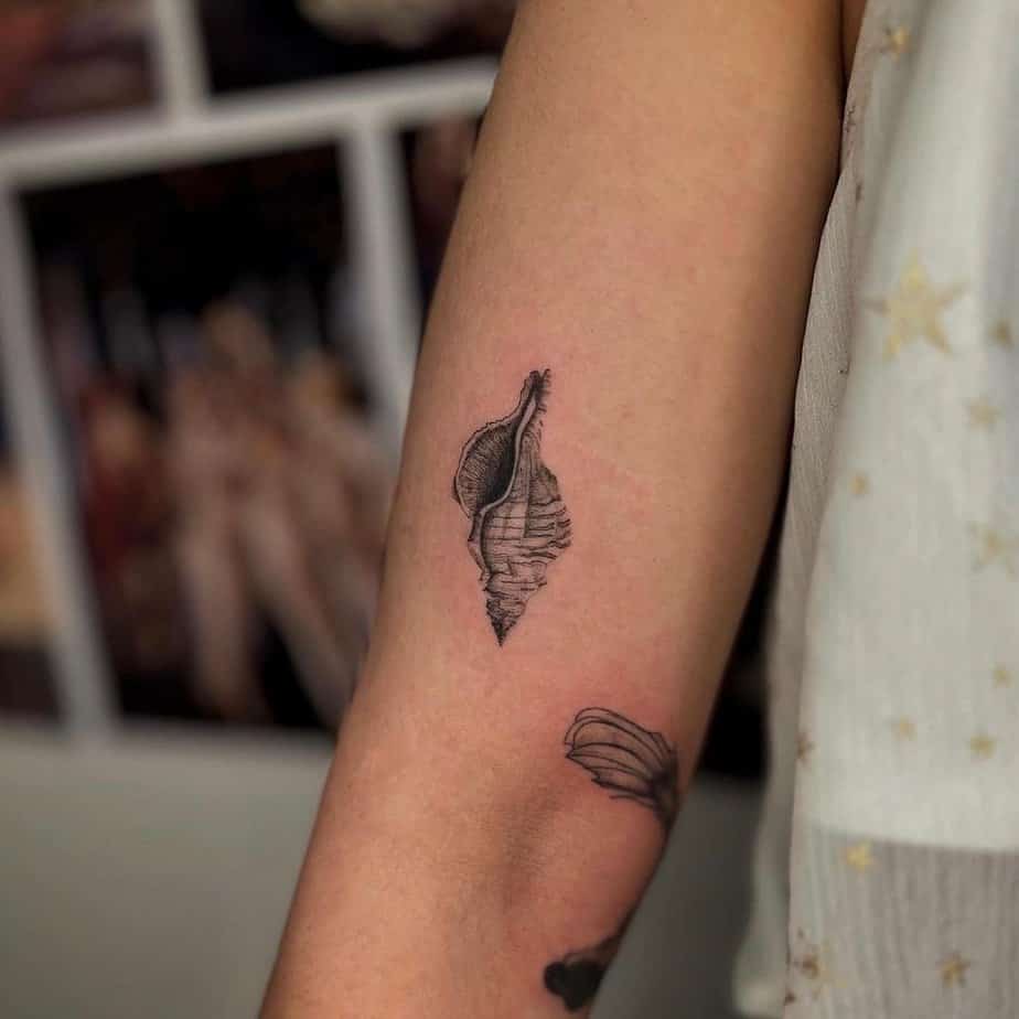 10. A drill shell tattoo on the arm