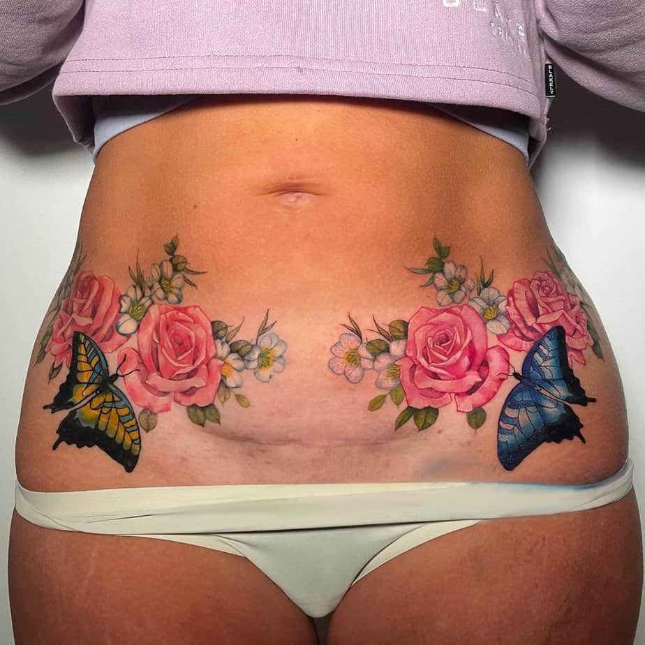 15. A floral tummy tuck tattoo with butterflies