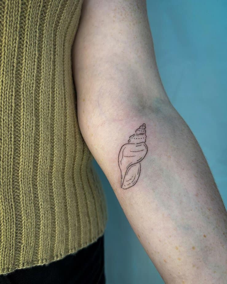 6. A hand-poked shell tattoo