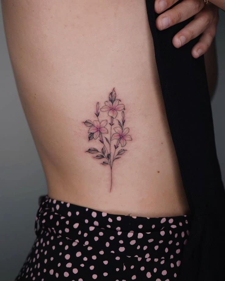 21. A jasmine tattoo on the side of the stomach