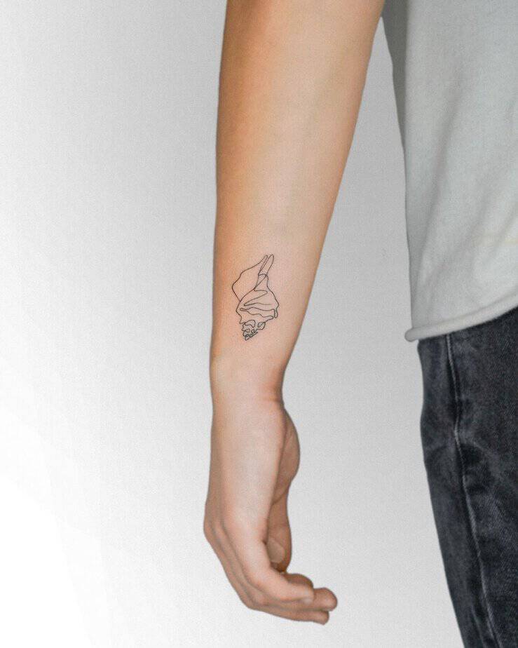 18. A linework shell tattoo
