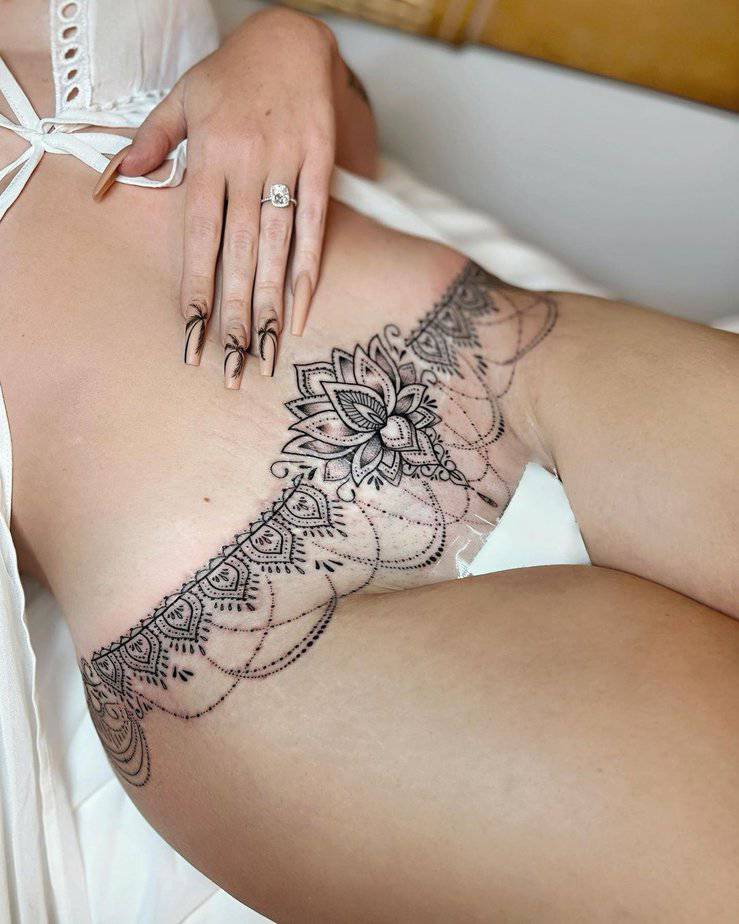 20. A lotus flower mandala tummy tuck tattoo