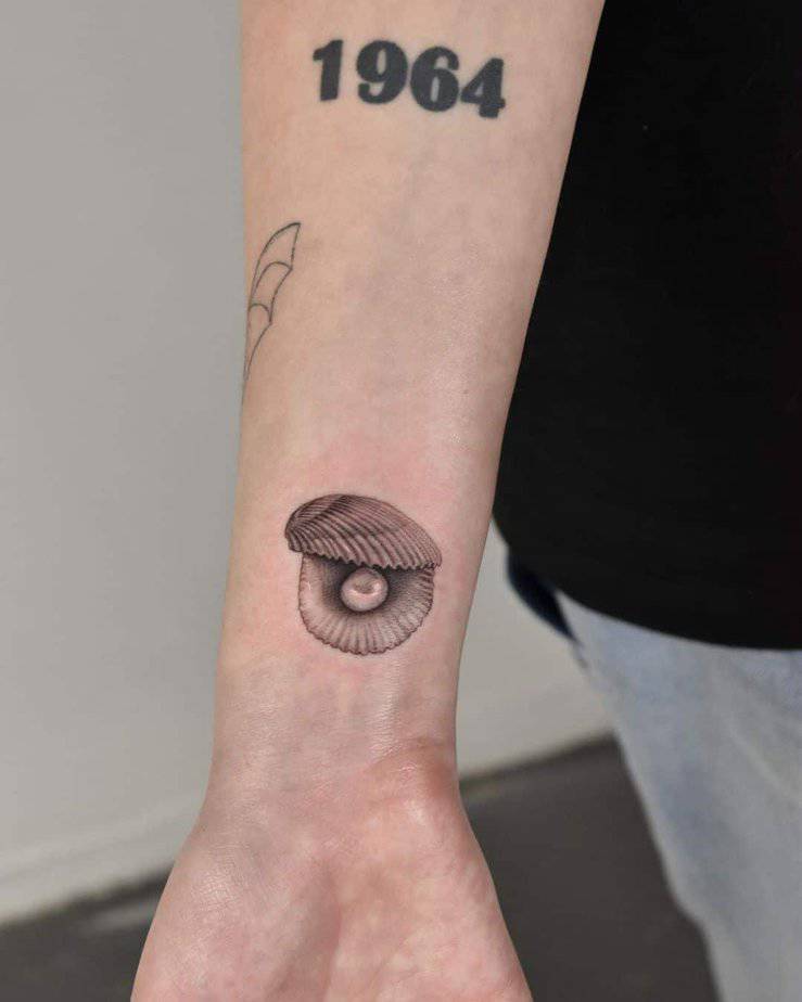 24. A tattoo of a shell with a pearl