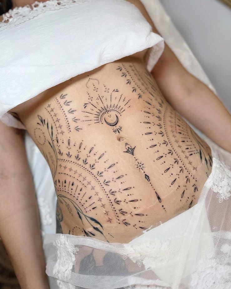 8. A tummy tuck tattoo across the entire stomach