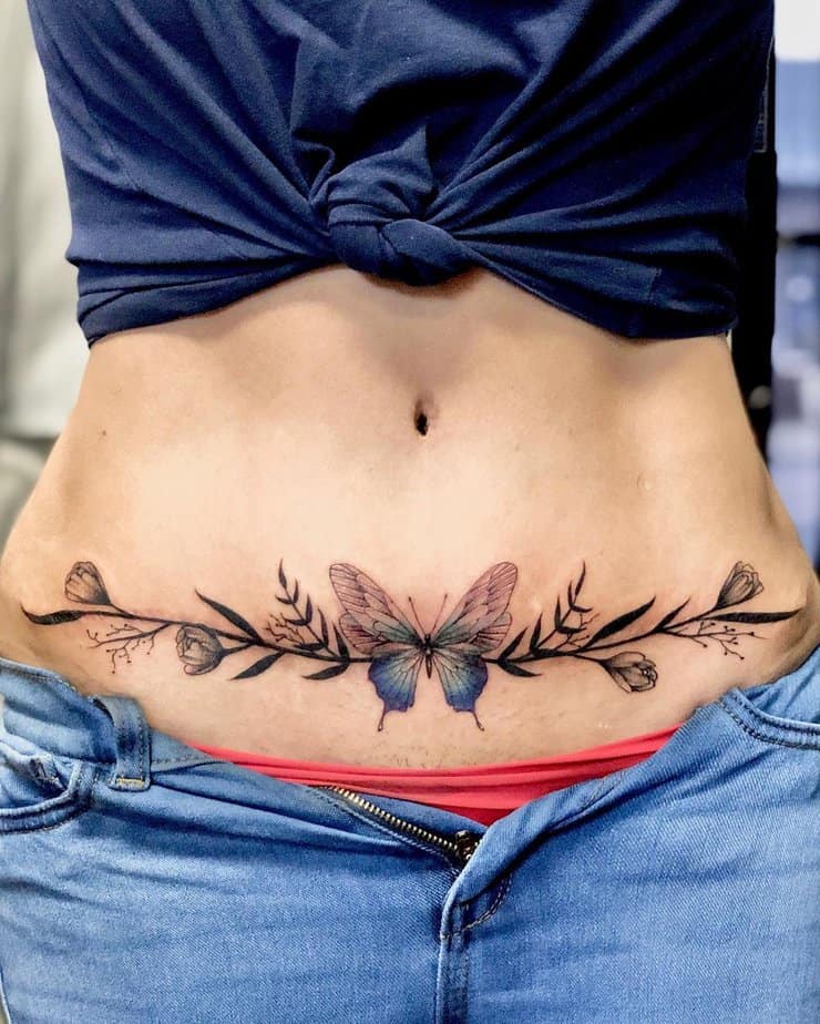 6. A tummy tuck tattoo with a colorful butterfly