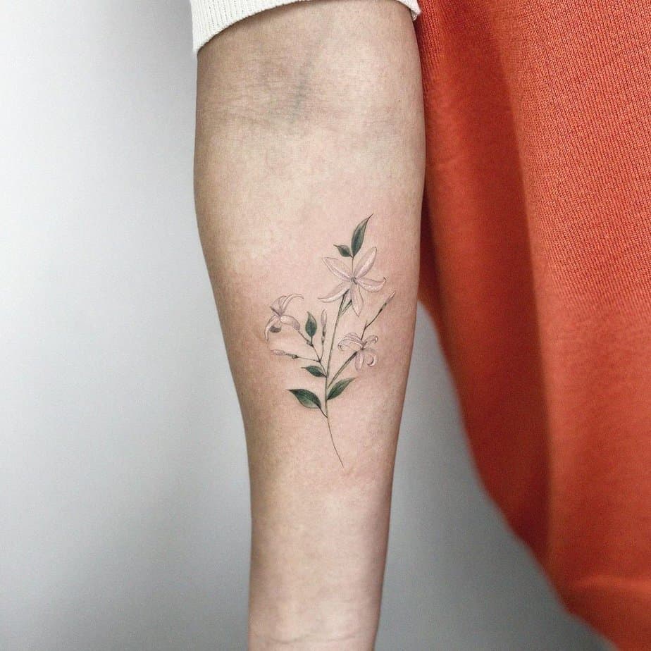 10. A white jasmine tattoo on the forearm