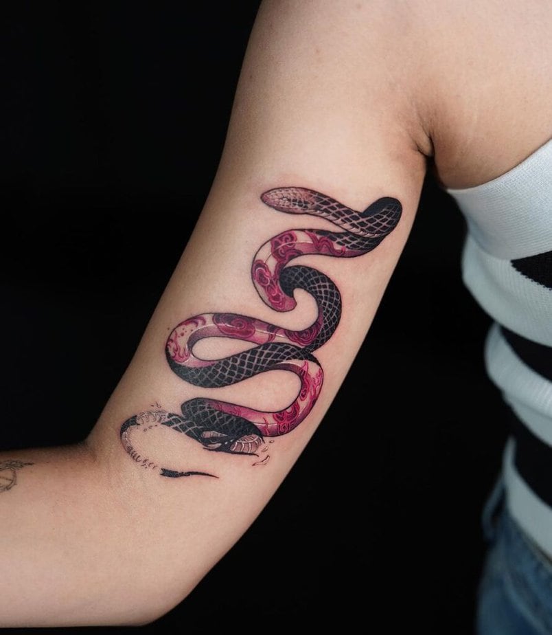 Enchanting snake and flowers tattoo