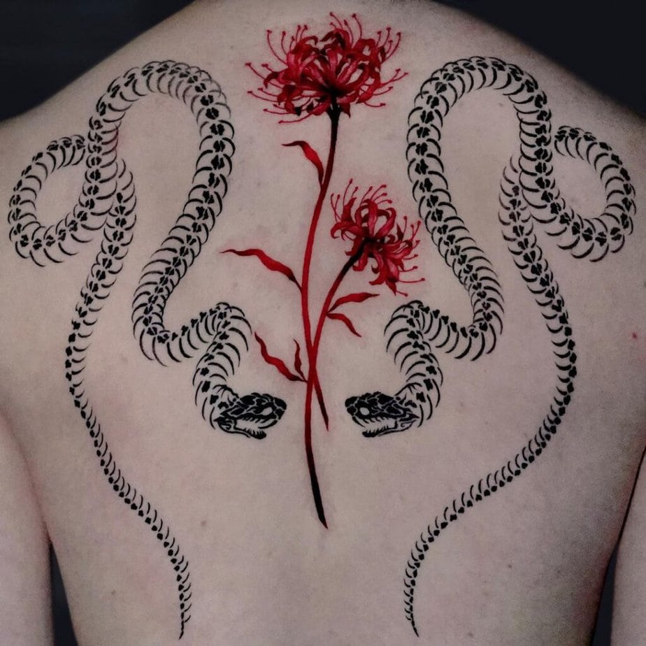 Snake skeleton tattoo with flowers