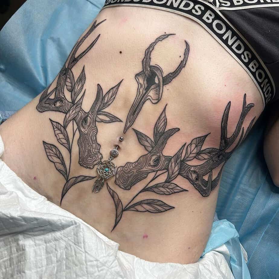 16. An abstract tummy tuck tattoo